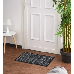 Tapis anti poussière à carreaux noir et blanc
